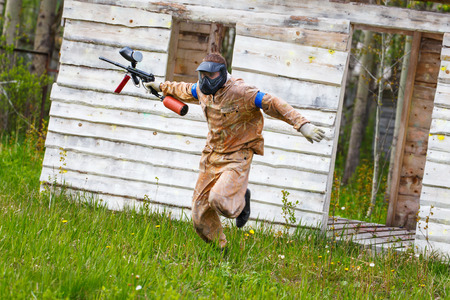 Dynamic paintball sportsman on the runの写真素材