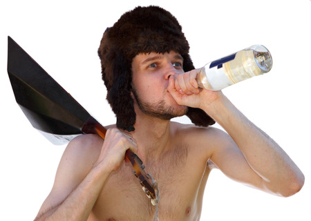 Russian man in fur hat with balalaika drinks vodka from bottleの写真素材