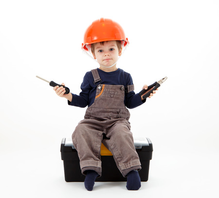 Cool repairman in hardhat with pliers and screwdriver on whiteの写真素材