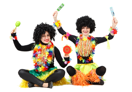 Two funny female aborigines in native costumes and wigs isolated on white