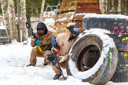 Cool paintball in winter. Two shooters behind fortifications.の写真素材