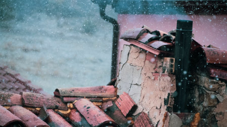 A chimney and snow in a villageの写真素材