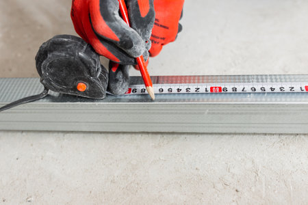 The master forms a metal profile from tin - construction of a frame wall
