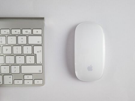 UK, October 2019: Apple mac wireless mouse and keyboard on white backgroundのeditorial素材