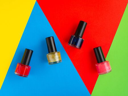 Nail varnish paint bottles on brightly coloured backgroundの写真素材