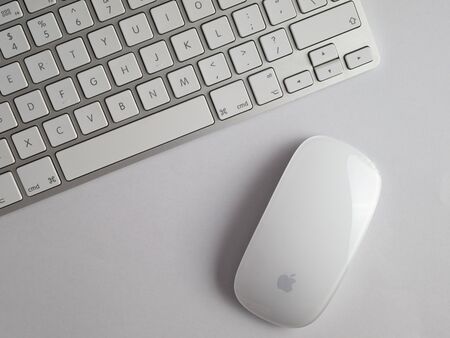 UK, October 2019: Apple mac mouse and wireless keyboard on white backgroundのeditorial素材
