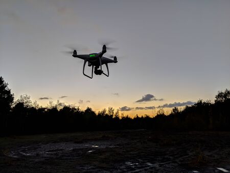 Drone silhouetted against sunset