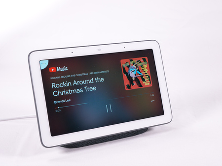 Nov 2019, UK - Google Nest Hub voice assistant speaker playing christmas tree music with touch controlsのeditorial素材