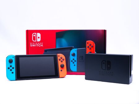 UK, Jan 2020: Nintendo switch games console and dock on white background with boxのeditorial素材