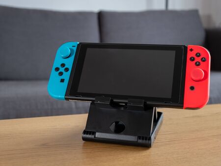 UK - Feb 2020: Nintendo switch hand held console on stand in home setting blank screen