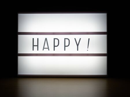 LED light box happy sign in darkの写真素材