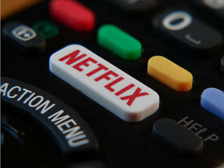 UK, March 2020: Close up of netflix button on remote control for tv television