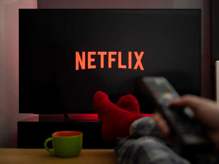 UK, March 2020: TV Television feet up watching Netflix on tvのeditorial素材