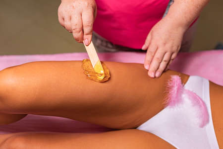 waxing procedure in a massage parlor wax on the bodyの写真素材