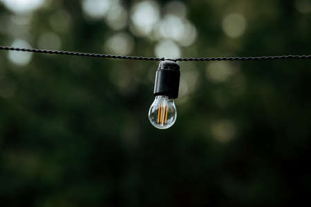 beautiful night yellow light bulbs on the streetの写真素材