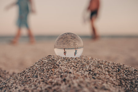 glass optical ball on the sandy azure coast of the sea. High quality photoの写真素材