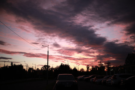 A sunset over a city street filled with lots of trafficの写真素材