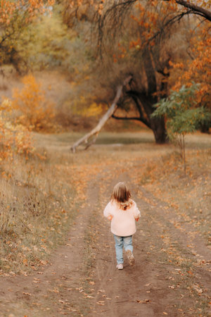 Family Walking Along Autumn Woodland Path Togetherの写真素材