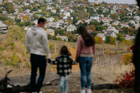 Family Walking Along Autumn Woodland Path Togetherの写真素材