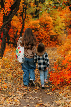 Family Walking Along Autumn Woodland Path Togetherの写真素材