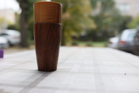 Elegant handmade wood water glass or wooden cup isolated on white background.の写真素材