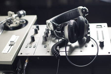 DJ mixer and headphones with a vinyl record, close up.の写真素材