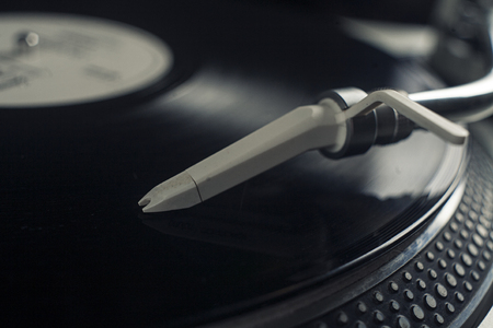 DJ mixer with a vinyl record, close up.の写真素材