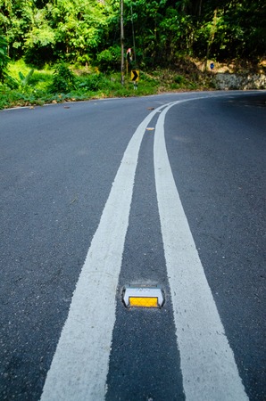 Empty road with reflectors in tropic forest