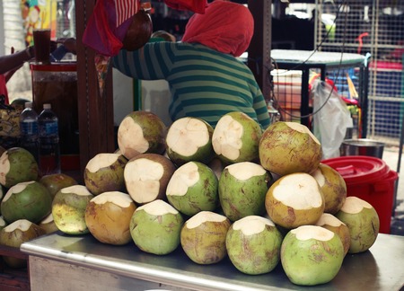 Woman sells coconut outdoor in Malaysiaの写真素材