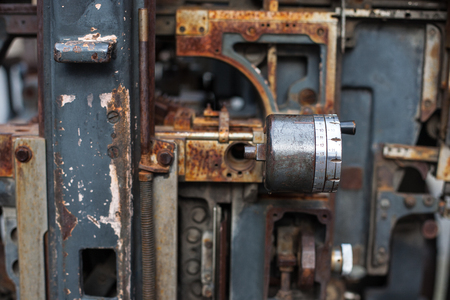 Old rusty printing machine complex mechanism of metal