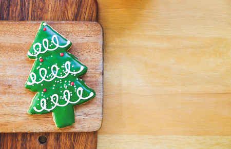 Christmas tree cookie on wood plate.の写真素材