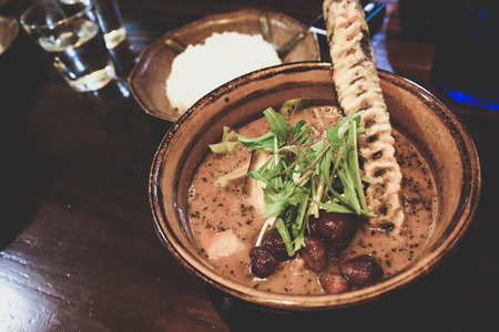 Japanese curry soup  served with fried Goboの写真素材