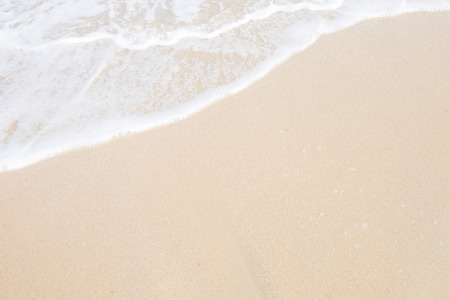 Wave roll into beach with white clean foamの写真素材