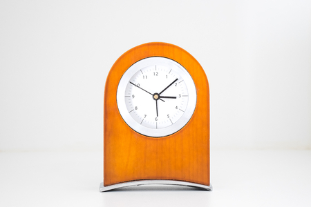 Brown wood clock white grey backgroundの写真素材
