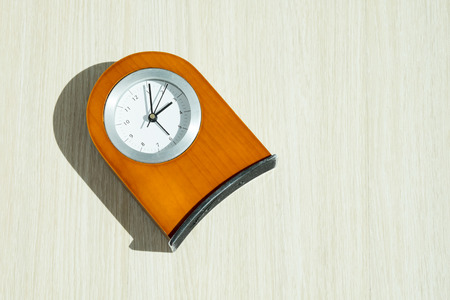 Brown wood clock on white background