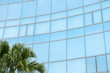 Modern building exterior with sky reflectionの写真素材