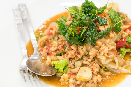 Thai food. Stir fried chicken with basil topped on noodleの写真素材