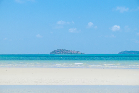 Calm white sand beach under blue skyの写真素材