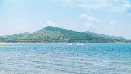 Beach and mountain in sunny day with faraway   windsufing backgroundの写真素材