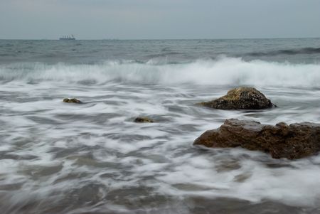 Coast with the vessel on the horizon.