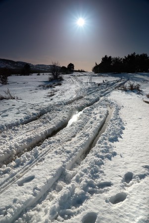 Winter snow road with sunshine star.の写真素材