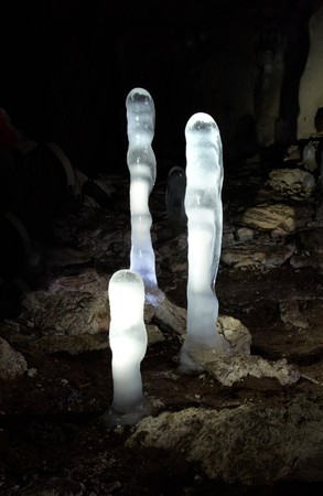 Luminescent ice stalagmites in the cave.