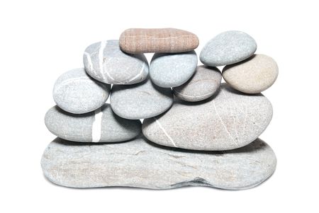Wall of gray pebbles isolated on white の写真素材