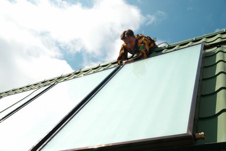 Erector of solar water heating system on the roof.の写真素材