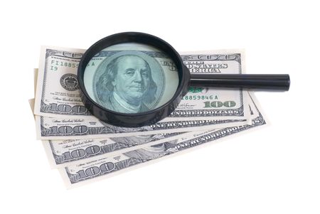 Magnifier with dollars isolated on white backgroundの写真素材