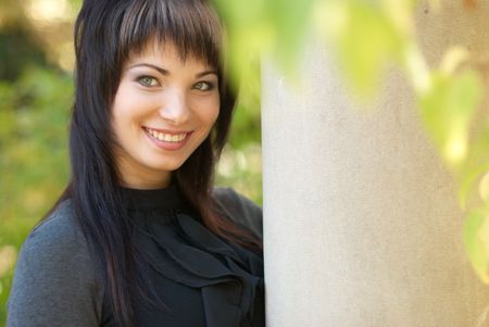 Beautiful girl's portrait near the column with soft backgroundの写真素材
