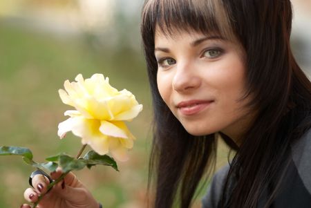 Beautiful girl with yellow rose, soft backgroundの写真素材