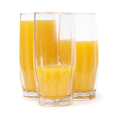 Three glasses with orange juice isolated on whiteの写真素材