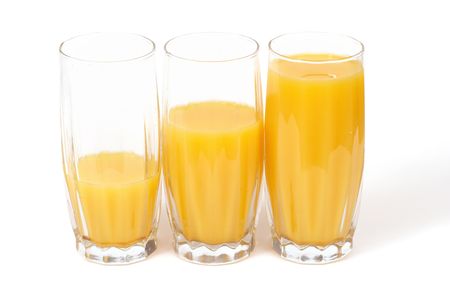 Three glasses with orange juice isolated on whiteの写真素材