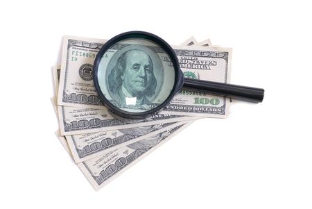 Magnifier with dollars isolated on white backgroundの写真素材